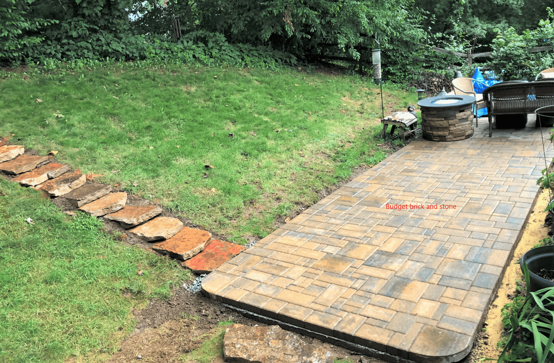 Paver patio on concrete. stepping stone steps up the hill.